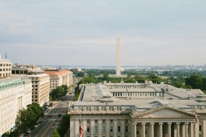 Grey concrete buildings in Washington D.C. with classic architecture and cloudy sky.—Things to Do in Washington D.C