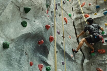 An image resembling a person participating in artificial rock climbing in India.