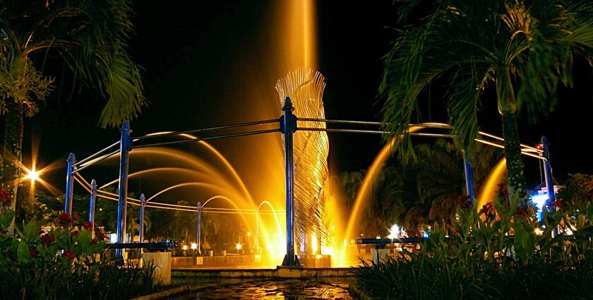 The illuminated fountain at Taman Bekapai in Balikpapan, glowing brightly at night.