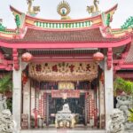 A glimpse of a spiritual attraction of Phuket adorned with red and gold decorations.