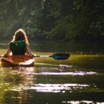 A serene experience of mangrove kayaking in Abu Dhabi, surrounded by lush green waterways