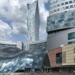 One of the shopping malls in Poland, with multiple floors, glass railings, and bright lighting.