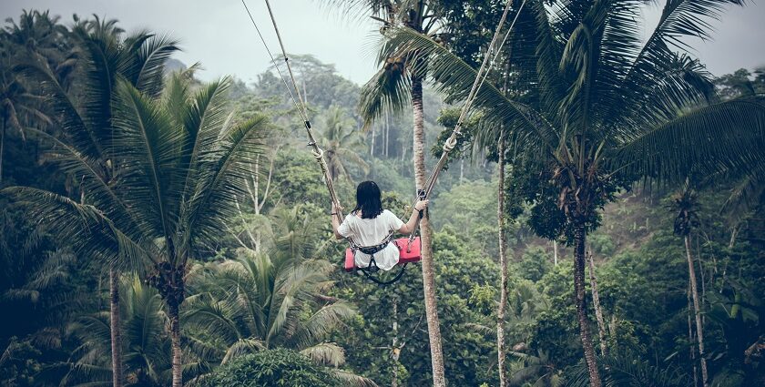 Experience the iconic Bali Swings in Ubud, soaring over lush rice terraces and dense forests for breathtaking views.