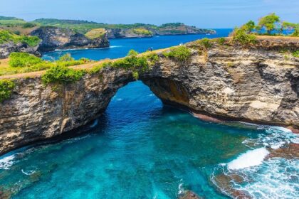 A breathtaking view of a natural bridge and archway on Nusa Penida, Indonesia.