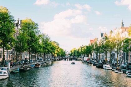 Canal waters reflecting sky, showing what Amsterdam is famous for: waterways