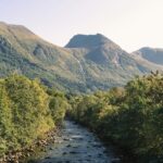 River flowing through Rosendal with scenic mountains, one of the best places to visit near Bergen.