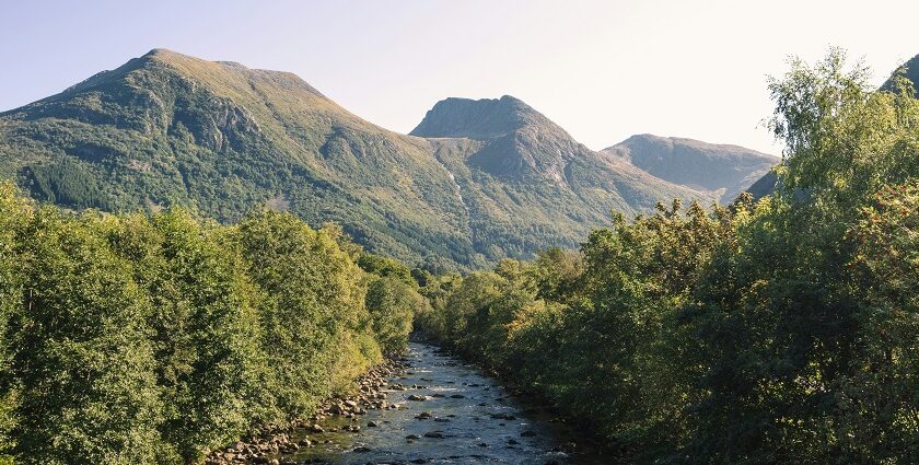 River flowing through Rosendal with scenic mountains, one of the best places to visit near Bergen.