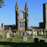 St Andrews Cathedral and St Rule's Tower ruins under blue sky, one of the best places to visit near Edinburgh.