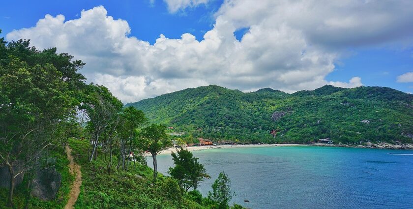 Aerial view of Koh Phangan with turquoise waters and lush hills, places to visit near Koh Samui.