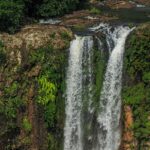 Orinduik Falls cascading over rocks with lush greenery—top things to do in Guyana.