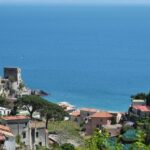 Maiori town with seafront promenade, pastel buildings, and lush hills on the Amalfi Coast, Maiori.