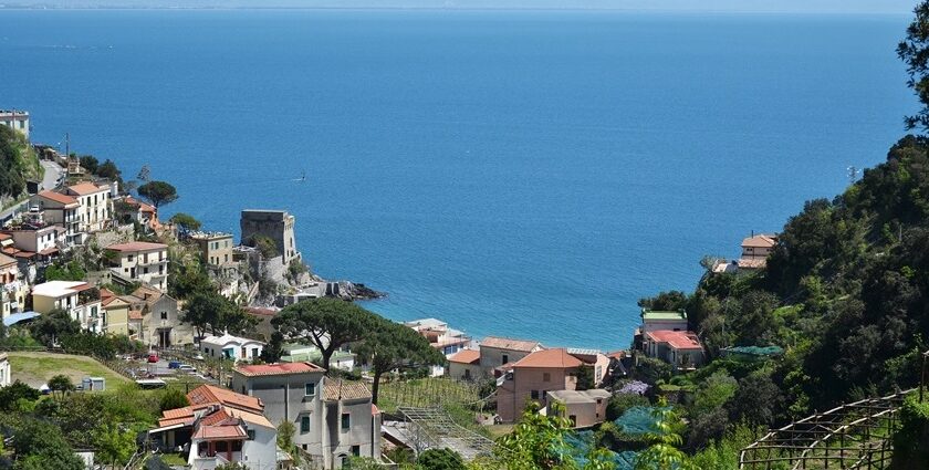Maiori town with seafront promenade, pastel buildings, and lush hills on the Amalfi Coast, Maiori.
