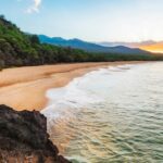 Relaxing at the Kaanapali Beach with sandy shores and distant mountains, one of the best things to do in Maui.