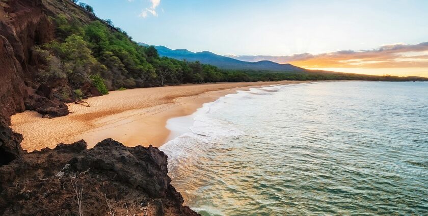 Relaxing at the Kaanapali Beach with sandy shores and distant mountains, one of the best things to do in Maui.