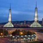 Oregon Convention Center in the evening with lit-up towers, multiple street lights and traffic lights, one of the best things to see in Oregon Ohio.