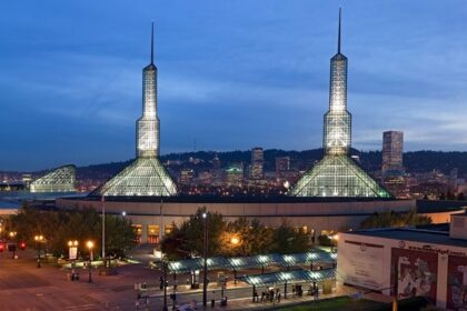 Oregon Convention Center in the evening with lit-up towers, multiple street lights and traffic lights, one of the best things to see in Oregon Ohio.