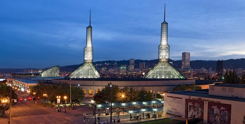 Oregon Convention Center in the evening with lit-up towers, multiple street lights and traffic lights, one of the best things to see in Oregon Ohio.