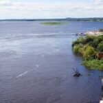 Paraguay River cruise with boats and lush greenery, showing things to do in Paraguay.