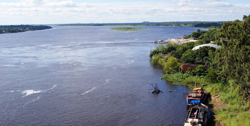 Paraguay River cruise with boats and lush greenery, showing things to do in Paraguay.