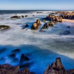 Relaxing at Punta del Este beach with ocean views and waves crashing on the rocks is among the things to do in Uruguay.