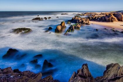 Relaxing at Punta del Este beach with ocean views and waves crashing on the rocks is among the things to do in Uruguay.