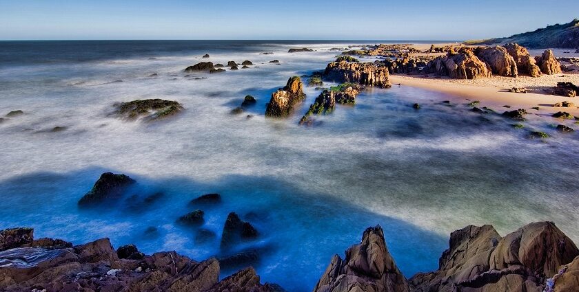 Relaxing at Punta del Este beach with ocean views and waves crashing on the rocks is among the things to do in Uruguay.