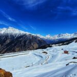 Auli snow covered mountains in winter among cold places to visit near Delhi.