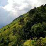 Chikmagalur green hills under cloudy skies, top places to visit in October near Bangalore.