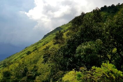Chikmagalur green hills under cloudy skies, top places to visit in October near Bangalore.
