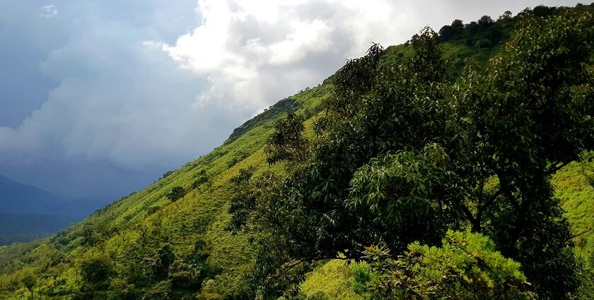 Chikmagalur green hills under cloudy skies, top places to visit in October near Bangalore.