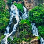 Chunchi Falls surrounded by rocks and greenery, one of the best places to visit near Bangalore for 1 day.