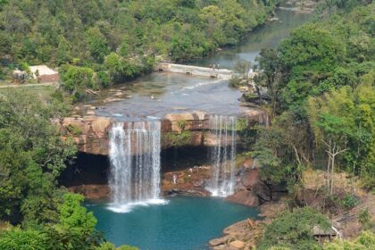 Khrangsuri Waterfall flowing into a blue pool with greenery places to visit near Barapani.
