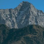 Snow-dusted mountains in Mcleodganj under clear sky are among places to visit near Dalhousie in December.