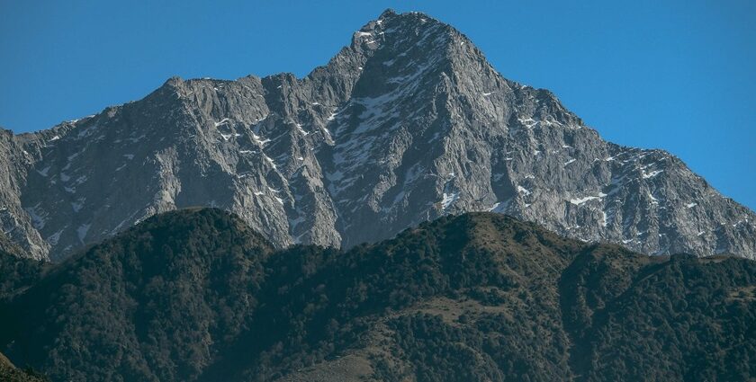 Snow-dusted mountains in Mcleodganj under clear sky are among places to visit near Dalhousie in December.