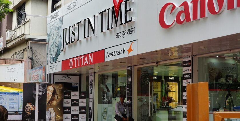 An image of FC Road, with various shops and visitors and two-wheelers parked outside.