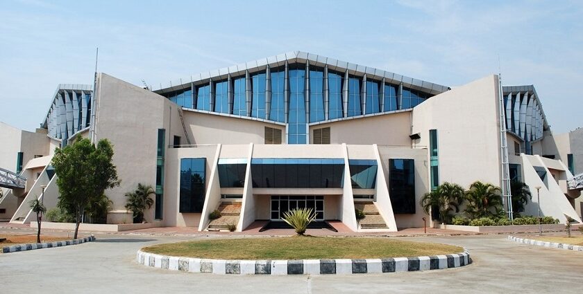 Modern architectural perspective of the Gachibowli Indoor Stadium under a blue atmosphere.
