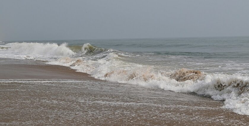 Marina Beach shoreline with waves and walkers, one of the top places to visit near Greams Road Chennai.