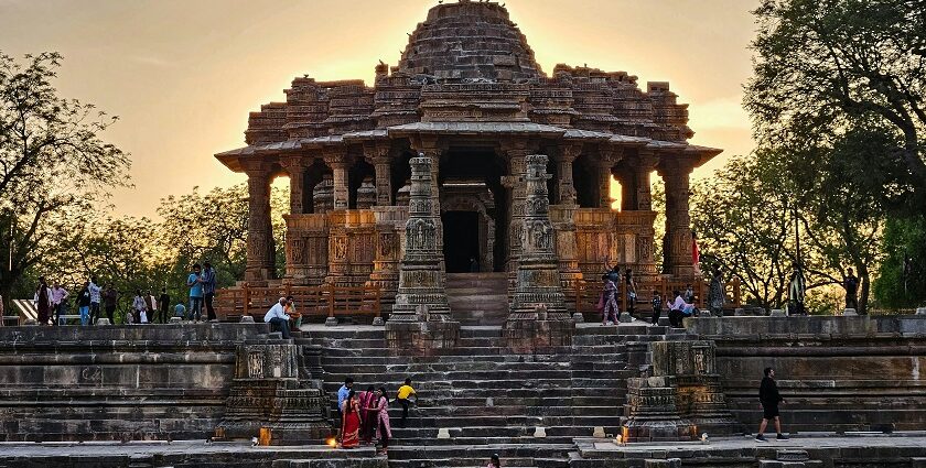 Ancient stone temple with intricate carvings gazing out to a stepped water tank beneath the sky