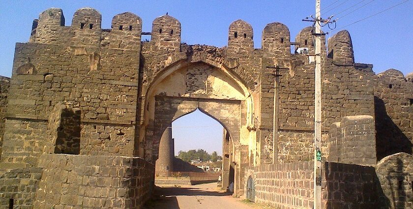 An image shows an empty pathway through the entrance of the Gulbarga Fort in Karnataka.
