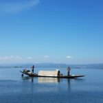 A boat floats peacefully on Loktak Lake, among top places to visit near Imphal.
