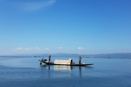 A boat floats peacefully on Loktak Lake, among top places to visit near Imphal.
