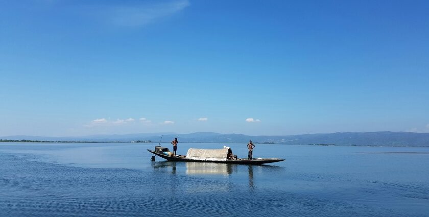 A boat floats peacefully on Loktak Lake, among top places to visit near Imphal.