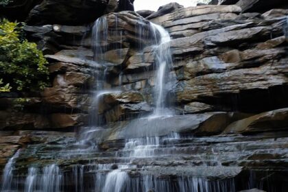 Patalpani Waterfall cascades over a rocky cliff, one of the scenic places to visit near Indore in July.