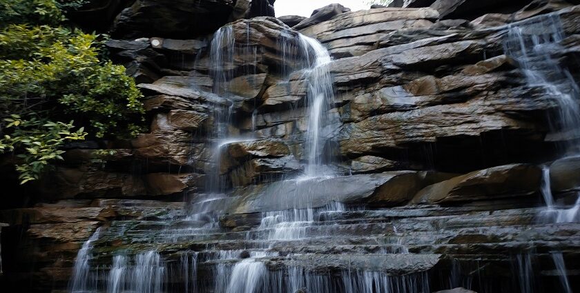 Patalpani Waterfall cascades over a rocky cliff, one of the scenic places to visit near Indore in July.