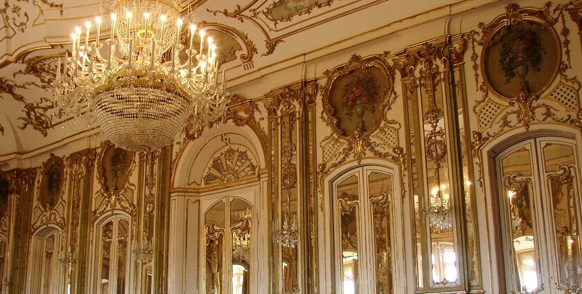 Elegant arched hall and chandeliers inside Elysee Palace, one of the top places to visit near Kapurthala.