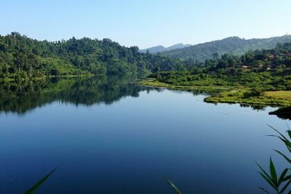 A scenic view of the Shilloi Lake surrounded by lush greenery, one of the stunning places to visit near Kohima.