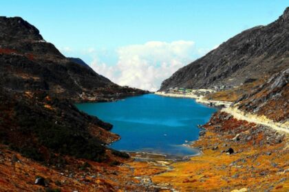 Black and brown mountain with lake in Sikkim showing what is Sikkim famous for.