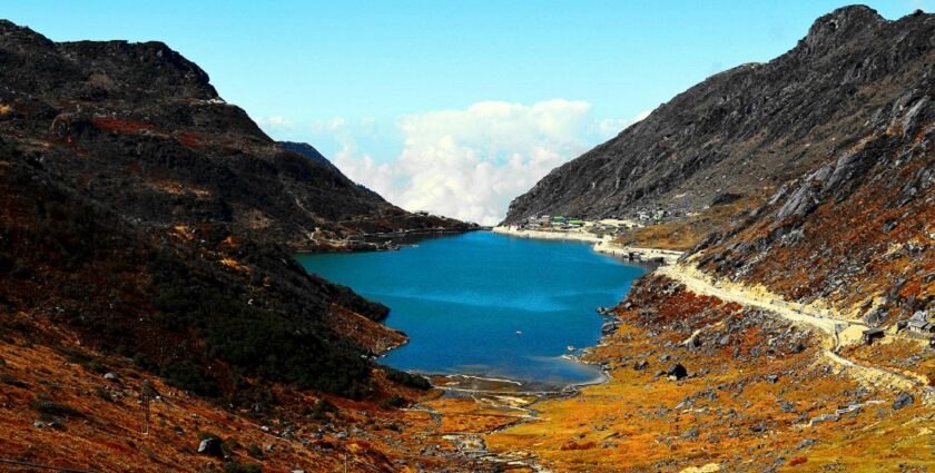 Black and brown mountain with lake in Sikkim showing what is Sikkim famous for.