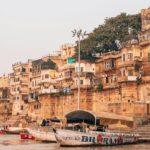 Varanasi ghat with pilgrims and boats, showcasing what is the best time to visit Varanasi.