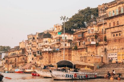 Varanasi ghat with pilgrims and boats, showcasing what is the best time to visit Varanasi.